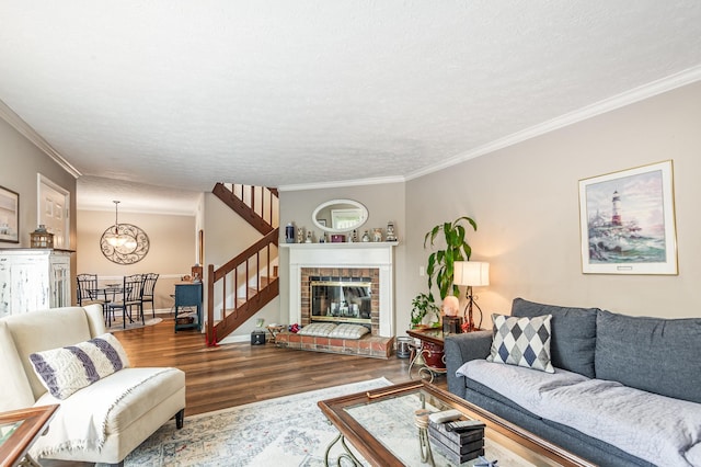 213 Cedarwood Ln, Madison, TN 37115 - living area featuring wood finished floors, stairs, crown molding, a chandelier, and a textured ceiling