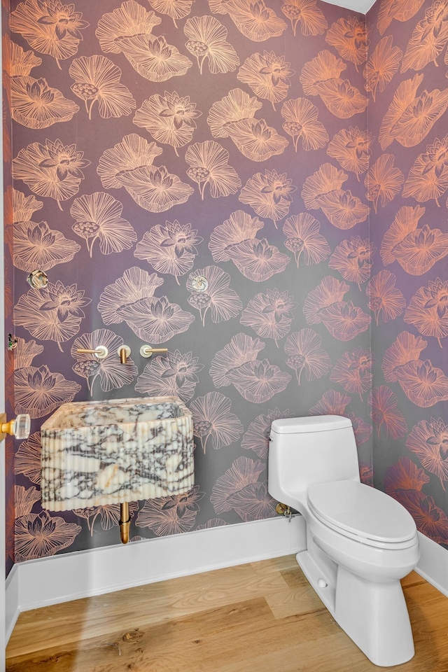 1806 Primrose Ave, Nashville, TN 37212 - half bathroom featuring baseboards, wood finished floors, toilet, and wallpapered walls