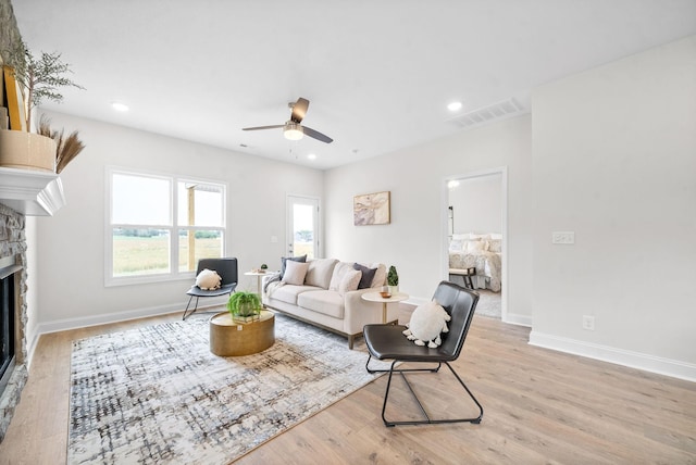 1002 Cherry Acres, Clarksville, TN 37042 - living room with a stone fireplace, ceiling fan, light wood-style flooring, baseboards, and recessed lighting