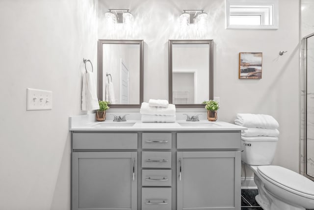 1002 Cherry Acres, Clarksville, TN 37042 - bathroom featuring toilet, double vanity, and a shower with shower door