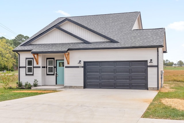 1002 Cherry Acres, Clarksville, TN 37042 - view of front of house with driveway, a garage, a shingled roof, and board and batten siding