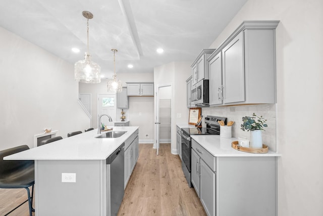 1002 Cherry Acres, Clarksville, TN 37042 - kitchen featuring appliances with stainless steel finishes, a sink, gray cabinets, recessed lighting, and a breakfast bar