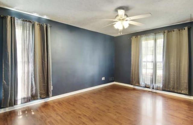 380 Station Dr, Waverly, TN 37185 - empty room featuring ceiling fan, wood finished floors, and baseboards