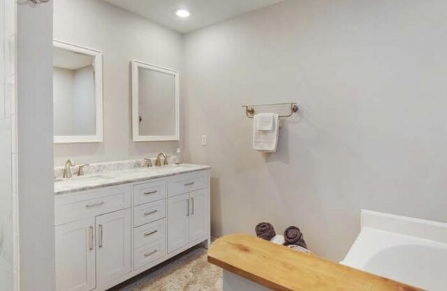 380 Station Dr, Waverly, TN 37185 - full bath with double vanity, a tub to relax in, and recessed lighting