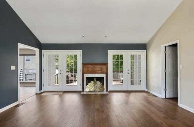 380 Station Dr, Waverly, TN 37185 - unfurnished living room featuring french doors, wood finished floors, baseboards, and high vaulted ceiling