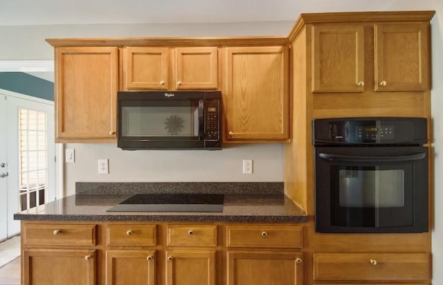 380 Station Dr, Waverly, TN 37185 - kitchen with black appliances, brown cabinetry, and dark stone counters