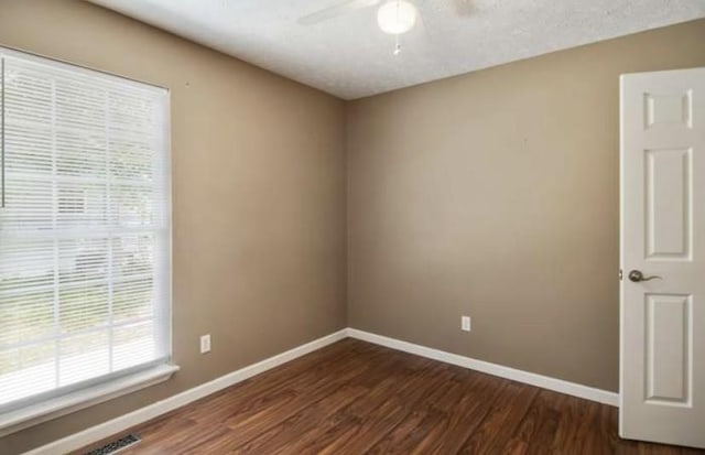 380 Station Dr, Waverly, TN 37185 - spare room with ceiling fan, baseboards, and dark wood finished floors