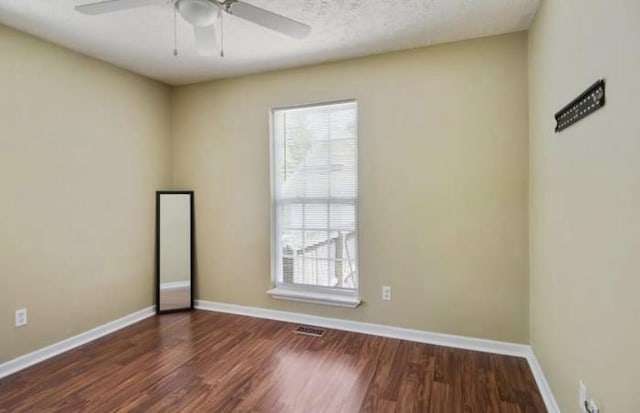 380 Station Dr, Waverly, TN 37185 - empty room with healthy amount of natural light, wood finished floors, and baseboards