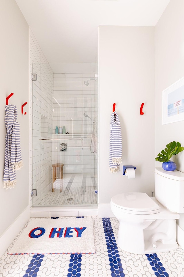 1400 Linden Ave, Nashville, TN 37212 - bathroom with toilet, a shower stall, tile patterned flooring, and baseboards