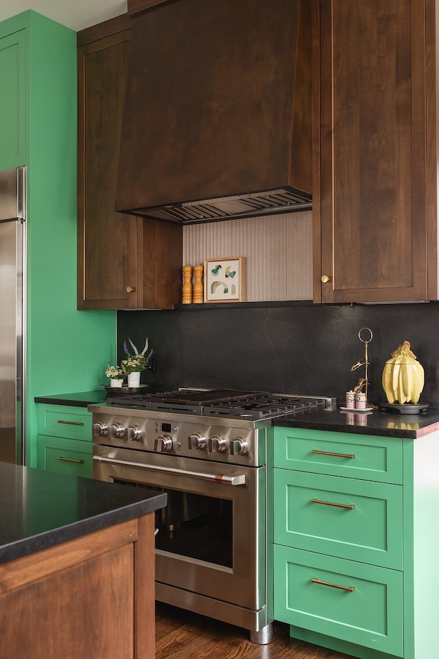 1400 Linden Ave, Nashville, TN 37212 - kitchen featuring appliances with stainless steel finishes, dark wood-type flooring, dark countertops, custom range hood, and green cabinets