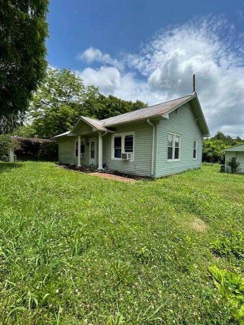 2034 Tennessee St, Westpoint, TN 38486 - back of house with a lawn and cooling unit