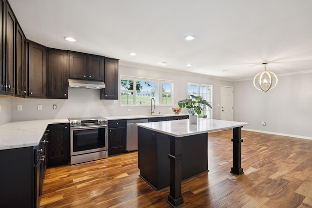 2408 Cantor Way, Spring Hill, TN 37174 - kitchen with stainless steel appliances, under cabinet range hood, a sink, wood finished floors, and crown molding