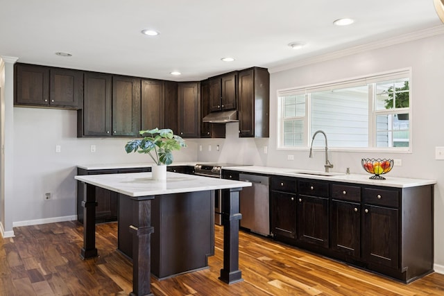 2408 Cantor Way, Spring Hill, TN 37174 - kitchen with a sink, appliances with stainless steel finishes, dark wood-type flooring, a kitchen breakfast bar, and crown molding