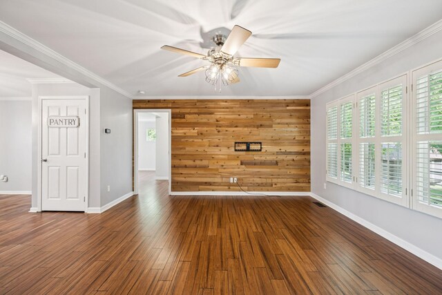 2408 Cantor Way, Spring Hill, TN 37174 - unfurnished living room with crown molding, ceiling fan, healthy amount of natural light, wood finished floors, and wood walls