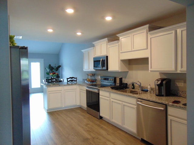 1920 Alysheba Run, Murfreesboro, TN 37128 - kitchen featuring stainless steel appliances, light wood-style floors, a sink, light stone countertops, and white cabinetry