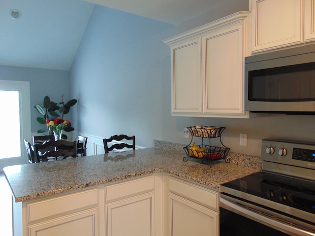 1920 Alysheba Run, Murfreesboro, TN 37128 - kitchen with stainless steel appliances, a peninsula, light stone counters, white cabinets, and lofted ceiling