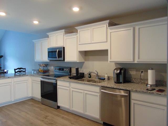 1920 Alysheba Run, Murfreesboro, TN 37128 - kitchen featuring appliances with stainless steel finishes, a sink, white cabinetry, light wood-style flooring, and light stone countertops