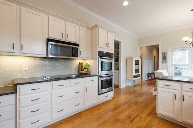3448 Colebrook Dr, Thompsons Station, TN 37179 - kitchen with appliances with stainless steel finishes, tasteful backsplash, crown molding, light wood-type flooring, and dark stone counters