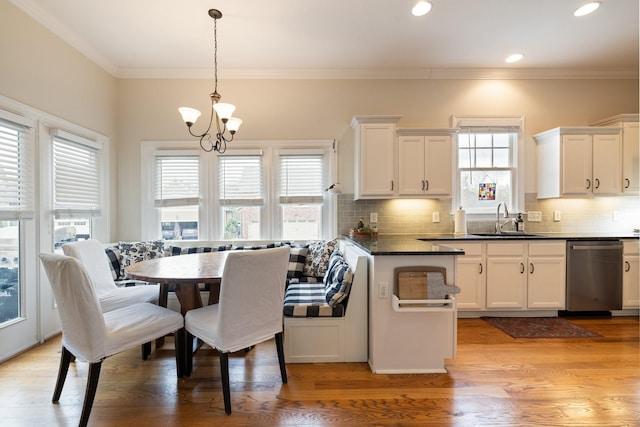 3448 Colebrook Dr, Thompsons Station, TN 37179 - kitchen featuring dishwasher, a sink, a chandelier, white cabinets, and backsplash