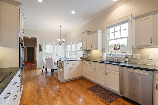 3448 Colebrook Dr, Thompsons Station, TN 37179 - kitchen with stainless steel appliances, a sink, a peninsula, backsplash, and crown molding
