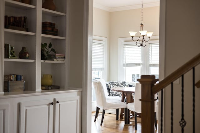 3448 Colebrook Dr, Thompsons Station, TN 37179 - dining space featuring a chandelier, crown molding, built in shelves, and light wood finished floors