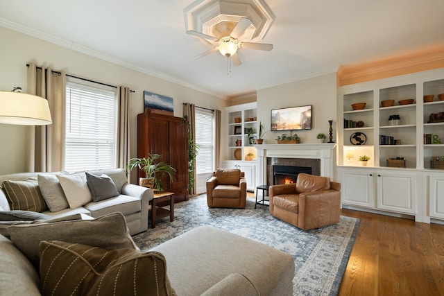 3448 Colebrook Dr, Thompsons Station, TN 37179 - living room featuring crown molding, wood finished floors, a lit fireplace, and ceiling fan