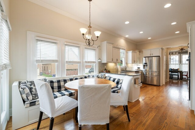 3448 Colebrook Dr, Thompsons Station, TN 37179 - dining space with crown molding, recessed lighting, light wood-style flooring, a ceiling fan, and a chandelier