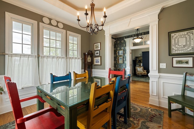 3448 Colebrook Dr, Thompsons Station, TN 37179 - dining room featuring decorative columns, wood finished floors, crown molding, a wainscoted wall, and a raised ceiling