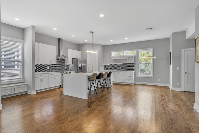 525 31st Ave N Unit A, Nashville, TN 37209 - kitchen featuring wall chimney range hood, stainless steel appliances, decorative backsplash, light countertops, and a sink