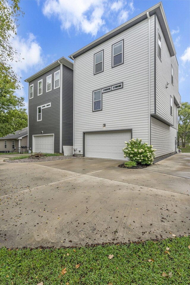525 31st Ave N Unit A, Nashville, TN 37209 - back of house with a garage and driveway
