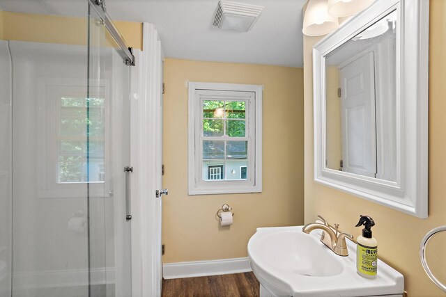 2614 Flamingo Dr, Nashville, TN 37207 - full bathroom with baseboards, a shower with door, and wood finished floors