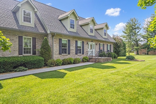 220 Winton Way Rd, Manchester, TN 37355 - cape cod house with brick siding, a front yard, and roof with shingles