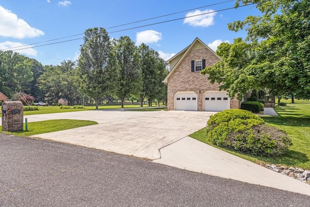 220 Winton Way Rd, Manchester, TN 37355 - view of front of house featuring an attached garage, stone siding, a front yard, and concrete driveway
