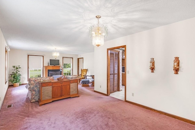 220 Winton Way Rd, Manchester, TN 37355 - living room featuring a chandelier, light colored carpet, baseboards, and a glass covered fireplace