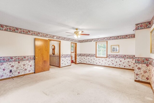 220 Winton Way Rd, Manchester, TN 37355 - carpeted spare room with wallpapered walls, ceiling fan, a wainscoted wall, and a textured ceiling