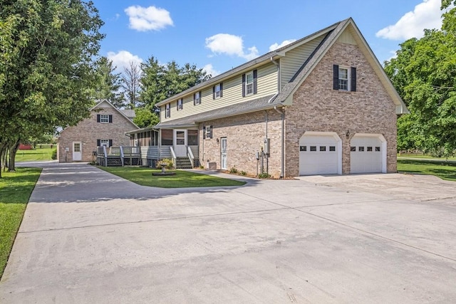 220 Winton Way Rd, Manchester, TN 37355 - traditional home featuring an attached garage, concrete driveway, brick siding, and a front lawn