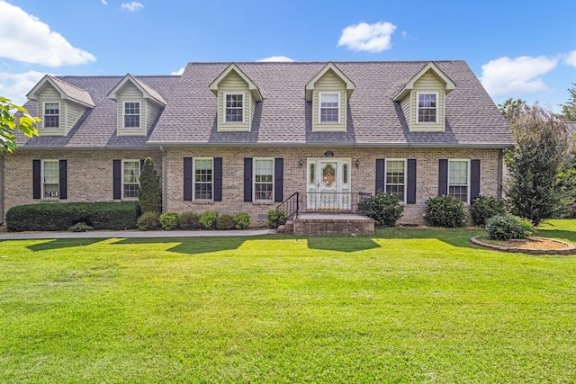 220 Winton Way Rd, Manchester, TN 37355 - cape cod house with brick siding, a front yard, and a shingled roof