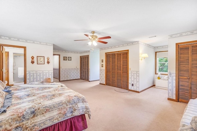 220 Winton Way Rd, Manchester, TN 37355 - carpeted bedroom featuring multiple closets, a wainscoted wall, and ceiling fan