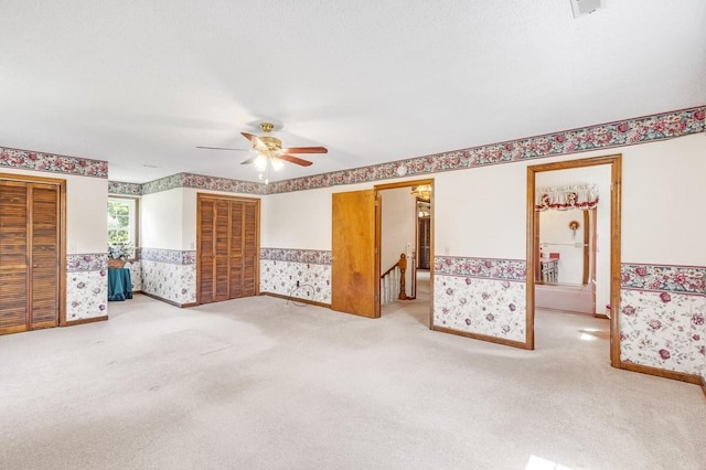 220 Winton Way Rd, Manchester, TN 37355 - unfurnished bedroom with wallpapered walls, wainscoting, carpet, and ceiling fan