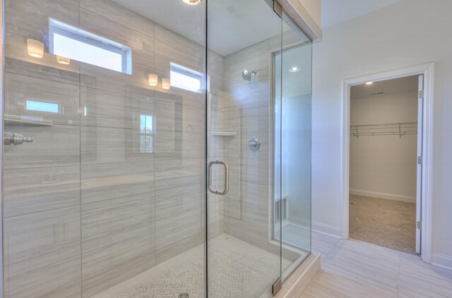 475 Triple Crown Cir, Gallatin, TN 37066 - bathroom featuring a stall shower, a walk in closet, and baseboards