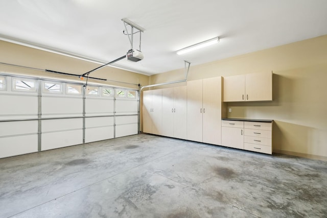 204 Magnolia Glen Ct, Manchester, TN 37355 - garage with a garage door opener and baseboards
