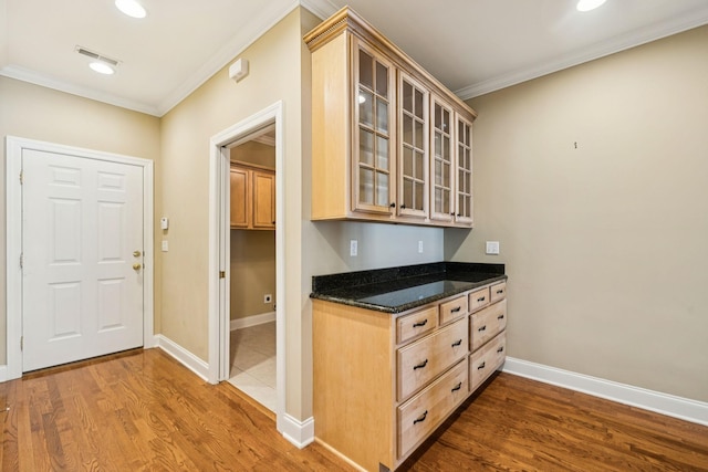 204 Magnolia Glen Ct, Manchester, TN 37355 - kitchen featuring ornamental molding, wood finished floors, glass insert cabinets, baseboards, and light brown cabinetry