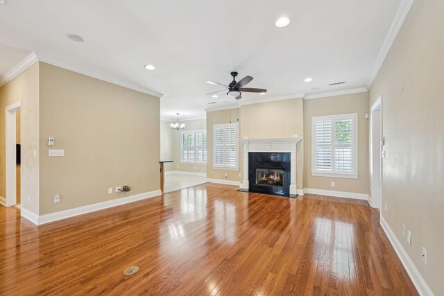 204 Magnolia Glen Ct, Manchester, TN 37355 - unfurnished living room featuring plenty of natural light, crown molding, wood finished floors, a ceiling fan, and a premium fireplace