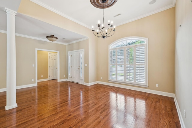 204 Magnolia Glen Ct, Manchester, TN 37355 - empty room with wood finished floors, ornate columns, crown molding, baseboards, and a chandelier