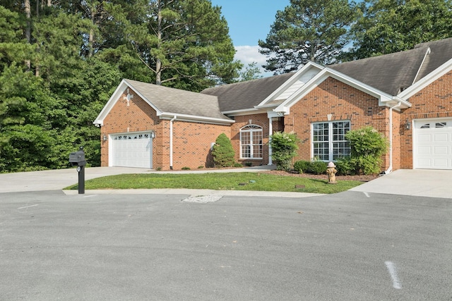 204 Magnolia Glen Ct, Manchester, TN 37355 - view of front of home featuring concrete driveway, brick siding, a garage, and roof with shingles