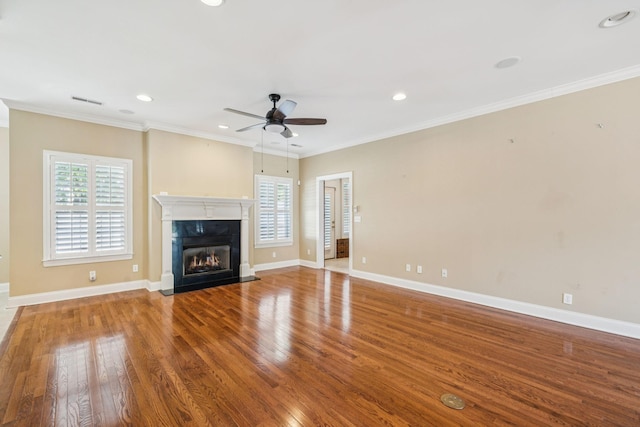 204 Magnolia Glen Ct, Manchester, TN 37355 - unfurnished living room featuring healthy amount of natural light, ceiling fan, a fireplace, wood finished floors, and crown molding