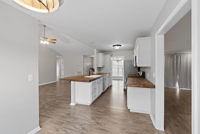 3609 Chunn Valley Dr, Spring Hill, TN 37174 - kitchen with butcher block counters, a sink, open floor plan, light wood finished floors, and lofted ceiling