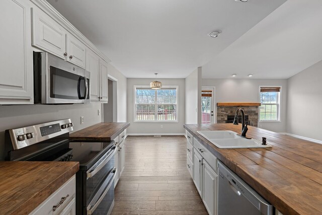 3609 Chunn Valley Dr, Spring Hill, TN 37174 - kitchen featuring wooden counters, appliances with stainless steel finishes, a sink, dark wood-type flooring, and white cabinets