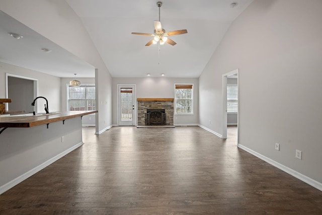 3609 Chunn Valley Dr, Spring Hill, TN 37174 - unfurnished living room with a ceiling fan, baseboards, dark wood finished floors, a fireplace, and a sink