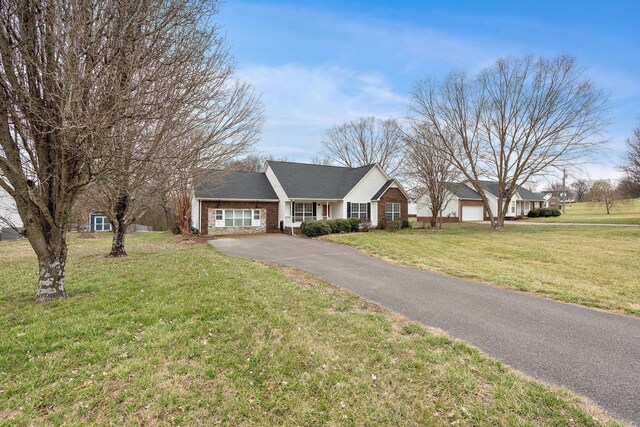 3609 Chunn Valley Dr, Spring Hill, TN 37174 - single story home featuring driveway, a front lawn, brick siding, and an attached garage